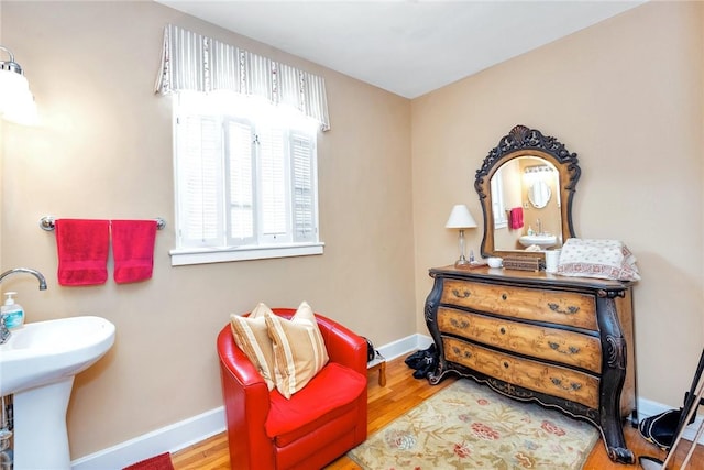 living area featuring baseboards and wood finished floors