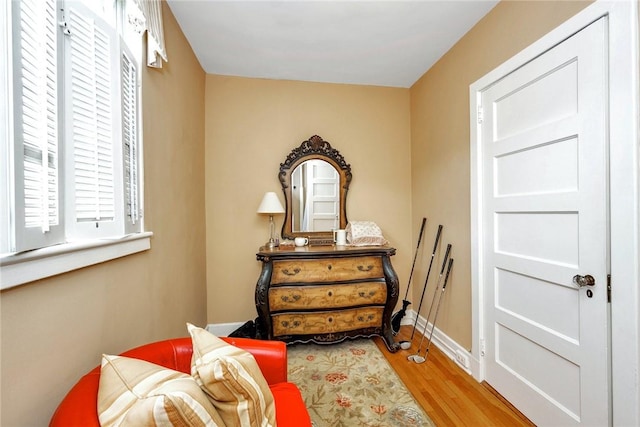 bedroom with baseboards and wood finished floors