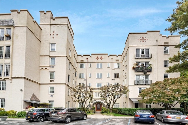 view of building exterior with uncovered parking