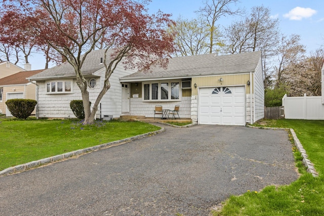 9 Thomas Dr, North Babylon, NY 11703 - view of front of home with fence, roof with shingles, driveway, and a garage