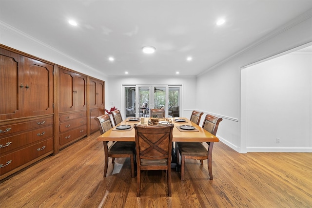 dining space with light wood-type flooring, recessed lighting, and ornamental molding