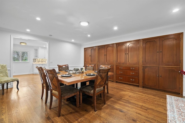 dining area with recessed lighting, light wood finished floors, and ornamental molding