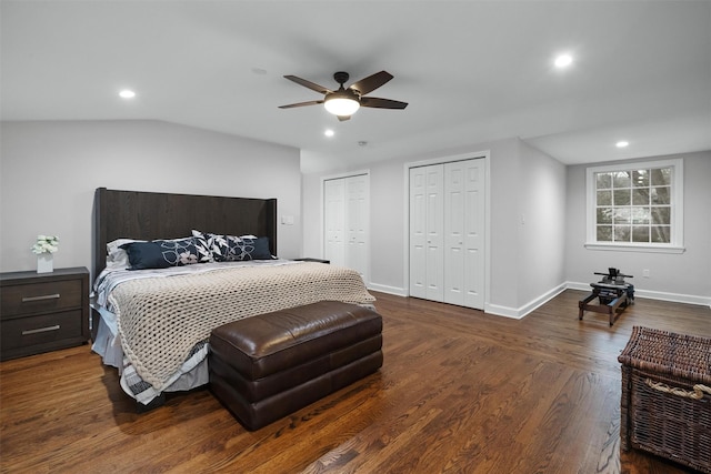 bedroom featuring baseboards, recessed lighting, a ceiling fan, wood finished floors, and multiple closets