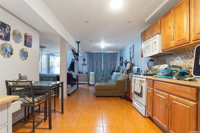 206-38 45th Rd, Bayside, NY 11361 - kitchen with brown cabinetry, light countertops, white appliances, and open floor plan