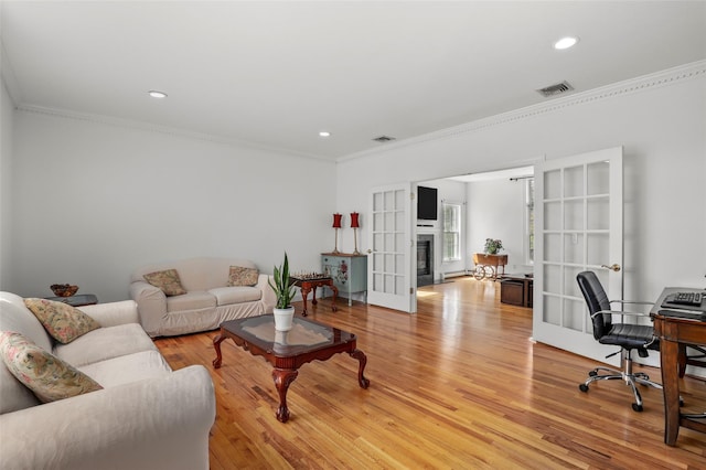 living area with french doors, light wood-style flooring, ornamental molding, visible vents, and recessed lighting