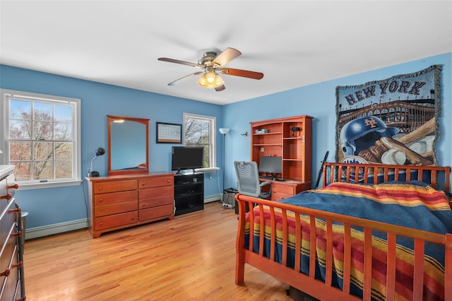 bedroom with baseboards, light wood-style flooring, baseboard heating, and ceiling fan