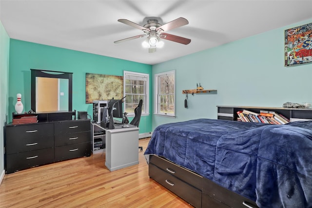 bedroom with light wood finished floors, ceiling fan, and a baseboard radiator