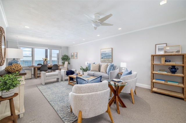 carpeted living area with crown molding, a ceiling fan, baseboards, and recessed lighting