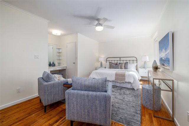 bedroom featuring wood finished floors, baseboards, ornamental molding, and a ceiling fan