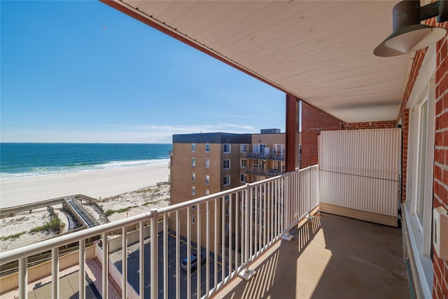 balcony with view of water and beach