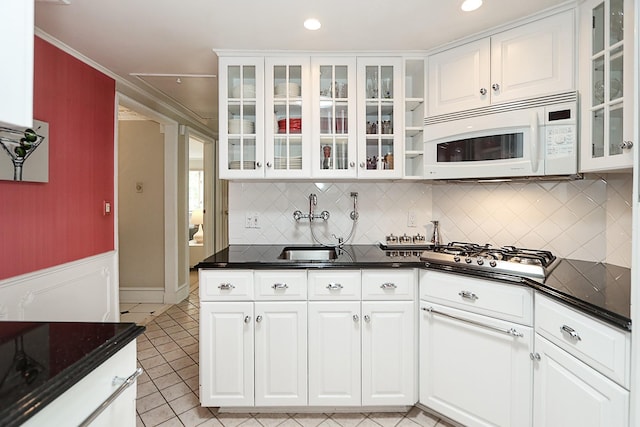 45 Holiday Blvd, Center Moriches, NY 11934 - kitchen featuring white microwave, stainless steel gas cooktop, a sink, light tile patterned floors, and white cabinets