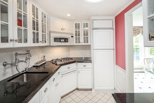 45 Holiday Blvd, Center Moriches, NY 11934 - kitchen with white microwave, a sink, stainless steel gas cooktop, white cabinetry, and backsplash