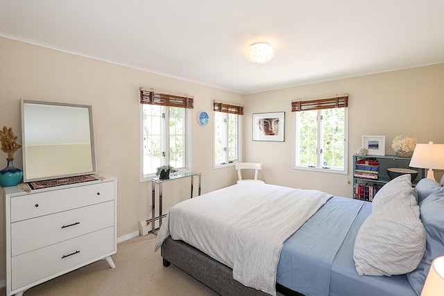 45 Holiday Blvd, Center Moriches, NY 11934 - bedroom featuring multiple windows, light colored carpet, a baseboard heating unit, baseboards, and ornamental molding