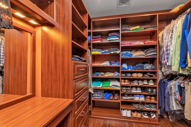 walk in closet featuring dark wood-type flooring