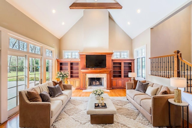 11 Victorian Ln, Brookville, NY 11545 - living room with high vaulted ceiling, a fireplace, light wood-type flooring, beamed ceiling, and recessed lighting