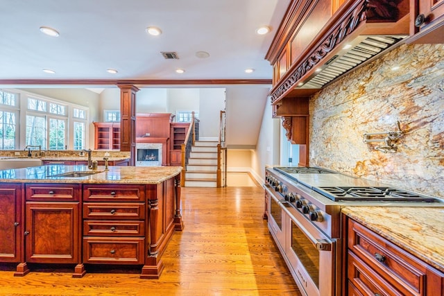 11 Victorian Ln, Brookville, NY 11545 - kitchen featuring double oven range, reddish brown cabinets, custom exhaust hood, tasteful backsplash, and recessed lighting
