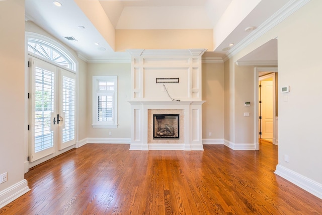 11 Victorian Ln, Brookville, NY 11545 - unfurnished living room featuring wood finished floors, a glass covered fireplace, french doors, ornamental molding, and recessed lighting