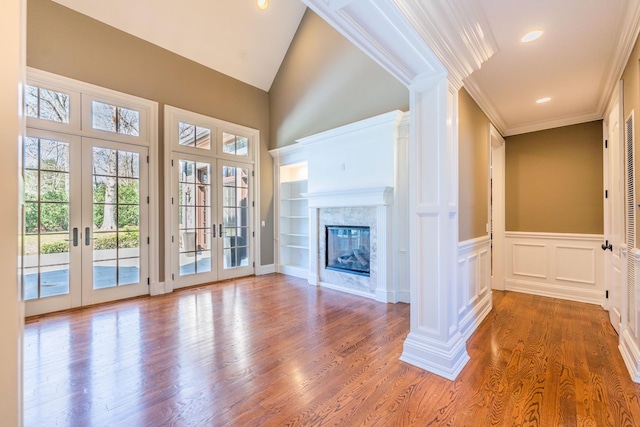 11 Victorian Ln, Brookville, NY 11545 - unfurnished living room featuring french doors, wood finished floors, ornate columns, a premium fireplace, and ornamental molding