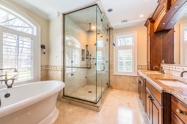 11 Victorian Ln, Brookville, NY 11545 - bathroom featuring ornamental molding, tile walls, a shower stall, a freestanding tub, and double vanity