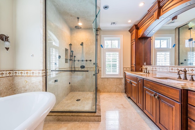 11 Victorian Ln, Brookville, NY 11545 - bathroom featuring tile walls, a freestanding tub, a stall shower, double vanity, and a wainscoted wall