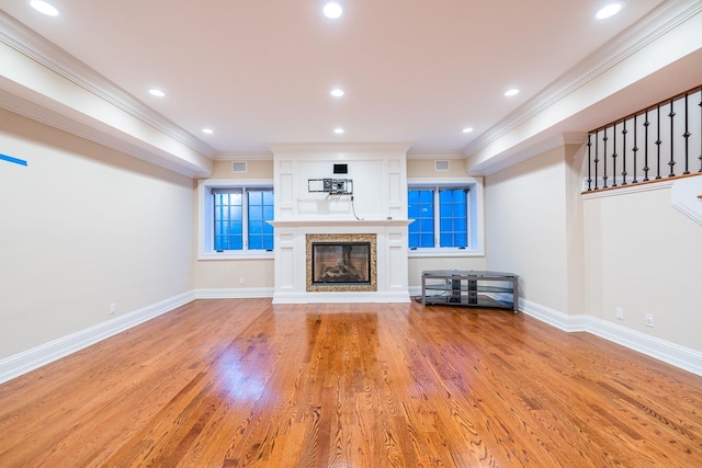 11 Victorian Ln, Brookville, NY 11545 - unfurnished living room featuring a high end fireplace, light wood-style floors, crown molding, and recessed lighting