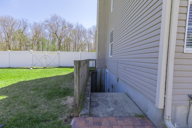 view of side of property with a fenced backyard and a yard
