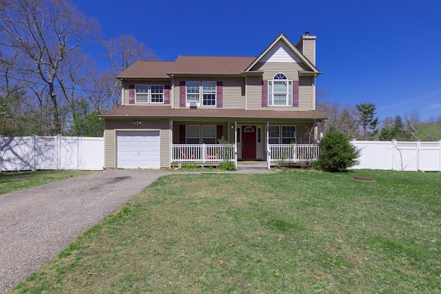 traditional-style home with a chimney, a front lawn, covered porch, an attached garage, and fence