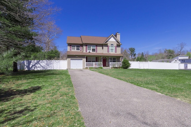 view of front of property with a garage, aphalt driveway, covered porch, and fence