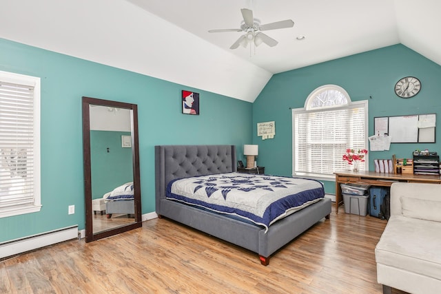bedroom featuring ceiling fan, lofted ceiling, baseboard heating, and wood finished floors