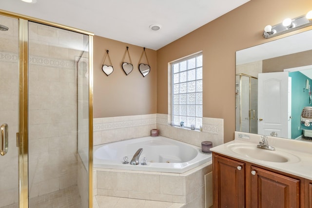 bathroom featuring vanity, a jetted tub, and a shower stall