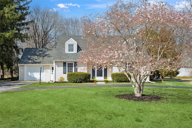 950 Main Bayview Rd, Southold, NY 11971 - view of front of home featuring an attached garage, roof with shingles, driveway, and a front lawn