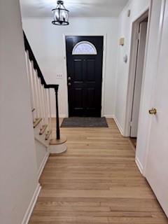 950 Main Bayview Rd, Southold, NY 11971 - foyer with stairs, baseboards, an inviting chandelier, and wood finished floors