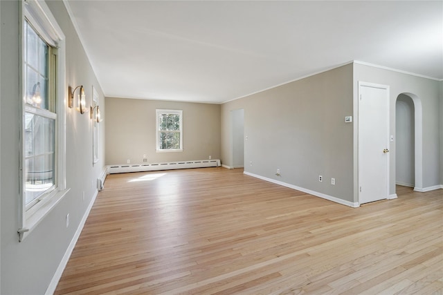 950 Main Bayview Rd, Southold, NY 11971 - spare room featuring light wood-style flooring, arched walkways, baseboards, and baseboard heating