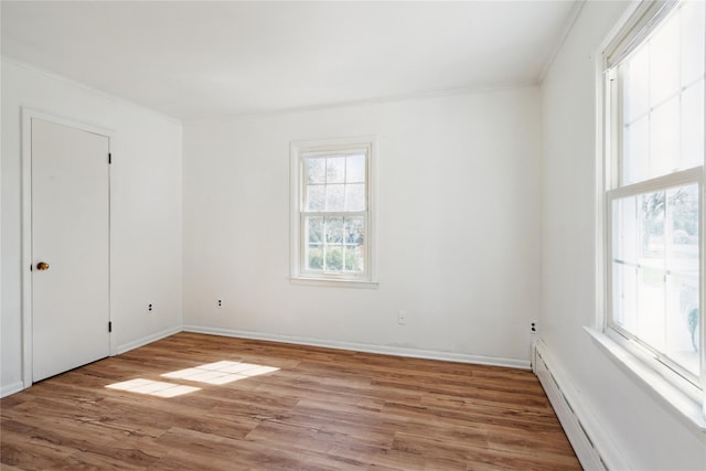 950 Main Bayview Rd, Southold, NY 11971 - empty room featuring baseboards, a baseboard radiator, crown molding, and wood finished floors