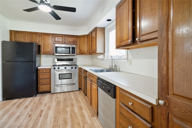 950 Main Bayview Rd, Southold, NY 11971 - kitchen with light countertops, light wood-style floors, brown cabinetry, stainless steel appliances, and a sink