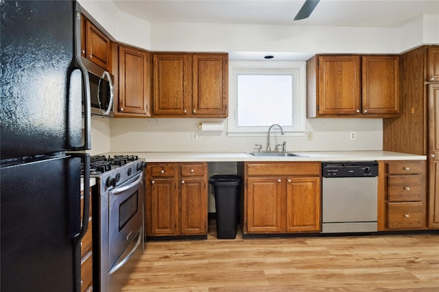950 Main Bayview Rd, Southold, NY 11971 - kitchen featuring a sink, brown cabinets, light wood-style flooring, and stainless steel appliances
