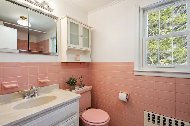 950 Main Bayview Rd, Southold, NY 11971 - bathroom with vanity, ornamental molding, toilet, radiator, and tile walls