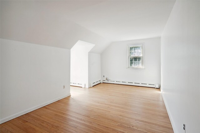 950 Main Bayview Rd, Southold, NY 11971 - bonus room featuring a baseboard radiator, vaulted ceiling, light wood-style floors, and baseboards