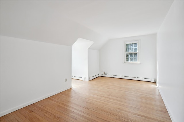 950 Main Bayview Rd, Southold, NY 11971 - bonus room featuring baseboards, light wood finished floors, vaulted ceiling, and baseboard heating