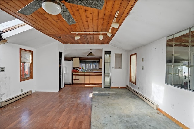 interior space with a baseboard heating unit, plenty of natural light, vaulted ceiling, and a baseboard radiator