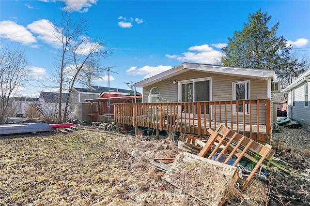 rear view of property featuring a deck