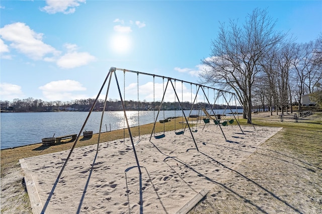 view of property's community featuring playground community and a water view