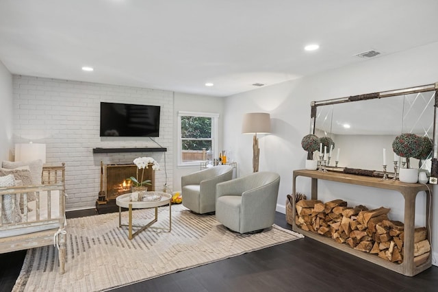 living room featuring recessed lighting, wood finished floors, a brick fireplace, and baseboards