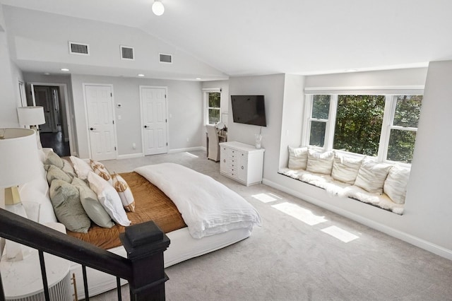 bedroom with vaulted ceiling, light carpet, visible vents, and baseboards