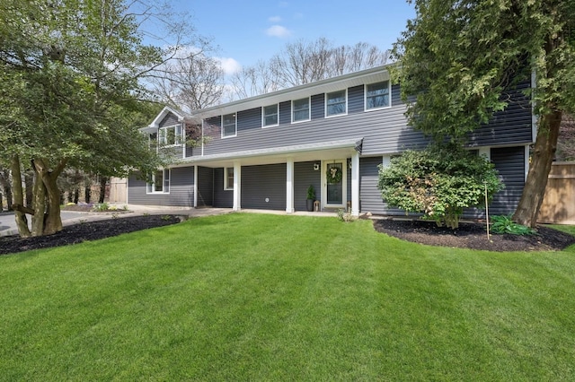view of front of property with fence and a front lawn