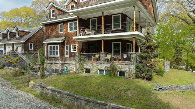 exterior space with a yard and a balcony