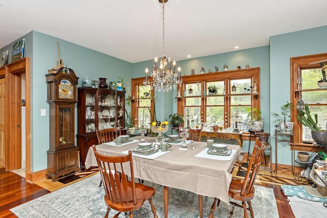 dining space with recessed lighting, baseboards, a chandelier, and wood finished floors