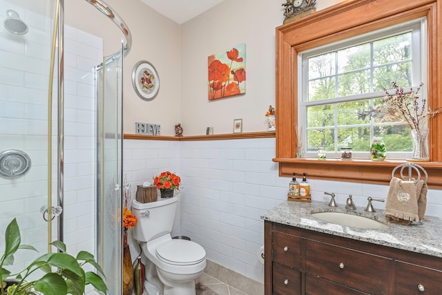 full bath featuring tile walls, tile patterned flooring, vanity, toilet, and tiled shower