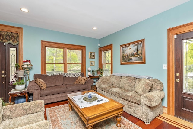 living room with recessed lighting and wood finished floors