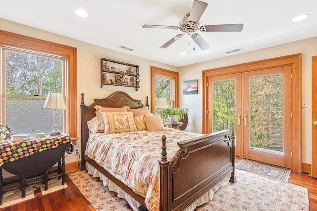 bedroom with visible vents, french doors, wood finished floors, and access to exterior
